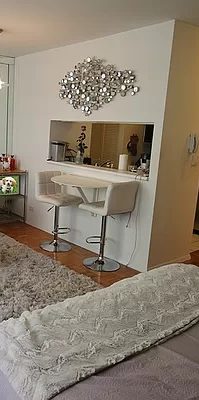 Photo of the partial living room showing the window to the kitchen with a small table and two tools.