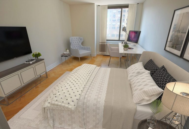 Master bedroom showing queen size bed, TV, lounge chair and a desk.