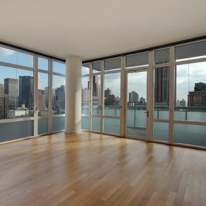 Nice modern living room with floor to ceiling glass windows.