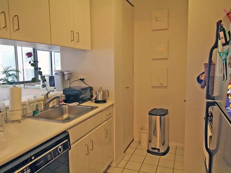 Nice picture of the kitchen showing dishwasher, sink, stove, and refrigerator.