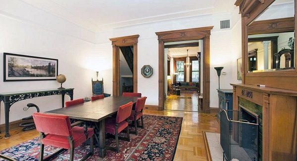 Dining area with a huge dinner table and fireplace.